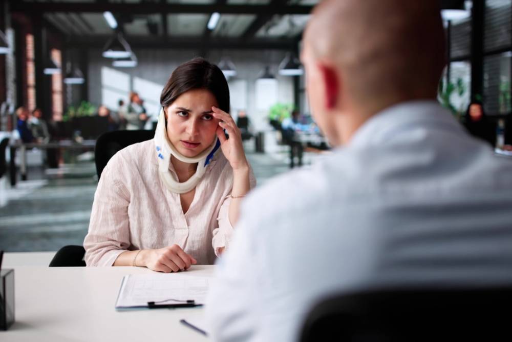 Unhappy Man Consults Lawyer For Workers' Compensation Case Meeting.